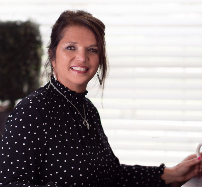 An image of tonia at desk smiling